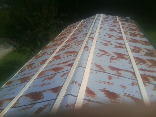 Rusted metal roof panels with new wood purlins before replacement — Storm Damage Roof Repair in Delta by Roofing Brothers